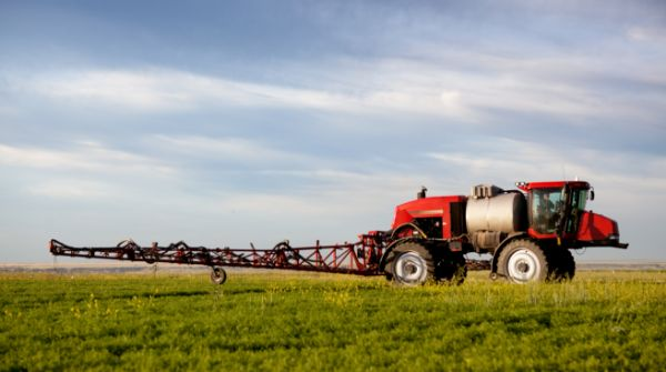 Red sprayer truck on farm